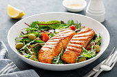 istock Grilled salmon fillet and fresh vegetable salad. Mediterranean diet. 1308223808