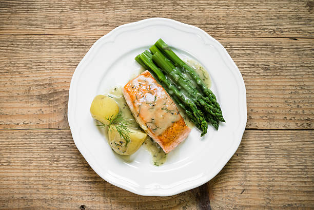 Grilled salmon with boiled potatoes and asparagus. Top view stock photo