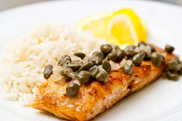 Grilled salmon with caper sauce Grilled salmon with caper sauce. caper stock pictures, royalty-free photos & images