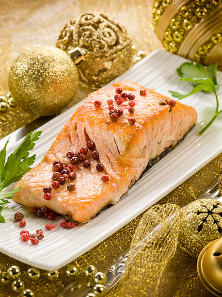 grilled salmon with pink pepper on christmas table stock photo