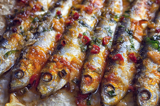 Grilled sardines on baking sheet stock photo