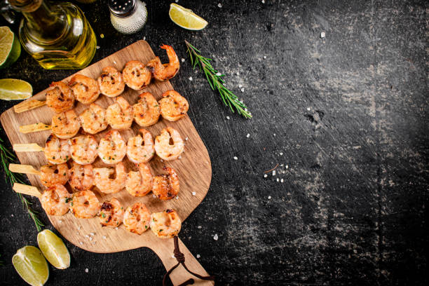 Grilled shrimp on a wooden cutting board. stock photo