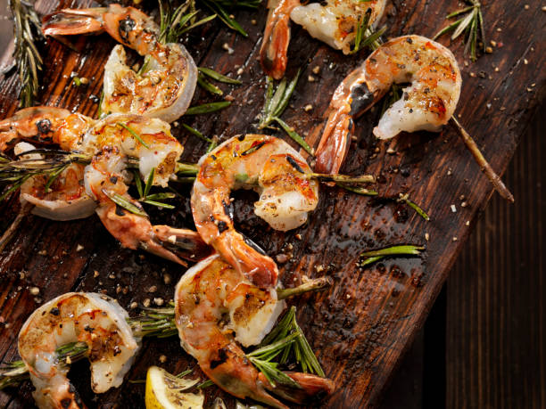 Grilled Shrimp on Rosemary Skewers Grilled Shrimp on Rosemary Skewers prawn seafood stock pictures, royalty-free photos & images