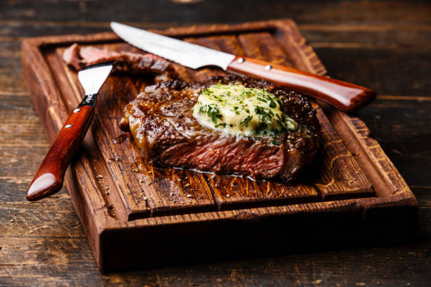Grilled steak Rib eye with herb butter stock photo