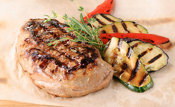 Grilled steak with zucchini and peppers stock photo