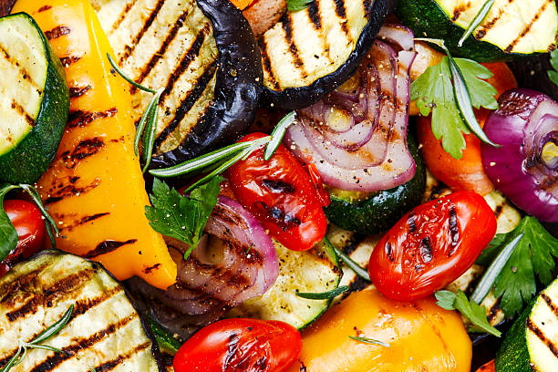 grilled vegetables. on cutting dark board background - gegrild stockfoto's en -beelden