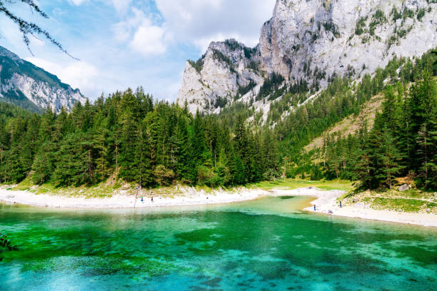 Grüner See (Green Lake) - mountain lake in Austria, surrounded by pine forests and massive mountains. Blue cloudy sky is on the background. stock photo