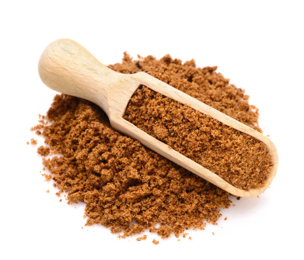 ground nutmeg powder n a wooden scoop stock photo