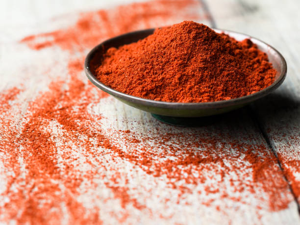Ground Paprika in a bowl Ground Paprika in a bowl on wooden table cayenne pepper stock pictures, royalty-free photos & images