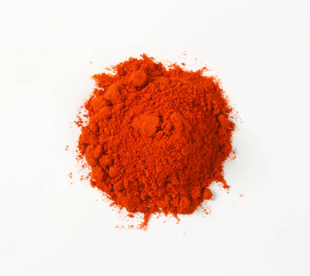 Ground Red Pepper Heap of ground red pepper on white background cayenne pepper stock pictures, royalty-free photos & images