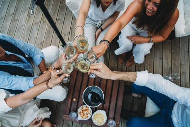 A group friends are toasting together with champagne stock photo