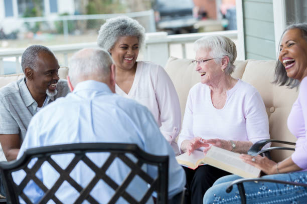 Group of active seniors participate in book club stock photo