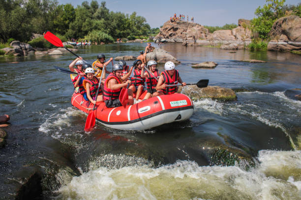 Group of adventurer enjoying water rafting activity at Southern Bug river  Ukraine. stock photo