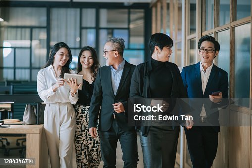 istock group of asian chinese successful office management team having discussion while walking toward camera 1284346714