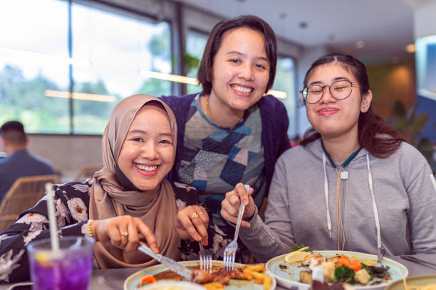 A group of asian ladies having lunch break together in a local restaurant stock photo