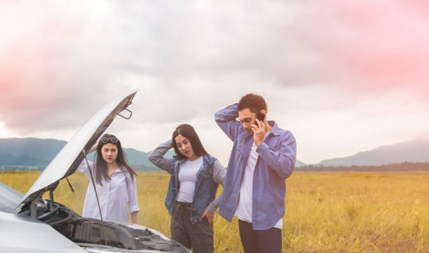 Group of Asian young having trouble car engine overheating and have smoke in parks outdoor stock photo