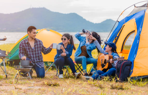 Group of Asian young sitting drinking coffee and playing guitar stock photo