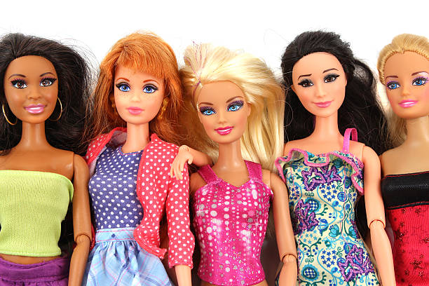 group of barbie doll friends posed on white background - barbie stockfoto's en -beelden