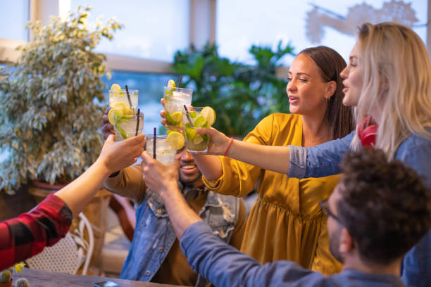 Group of best friends toasting and partying together stock photo