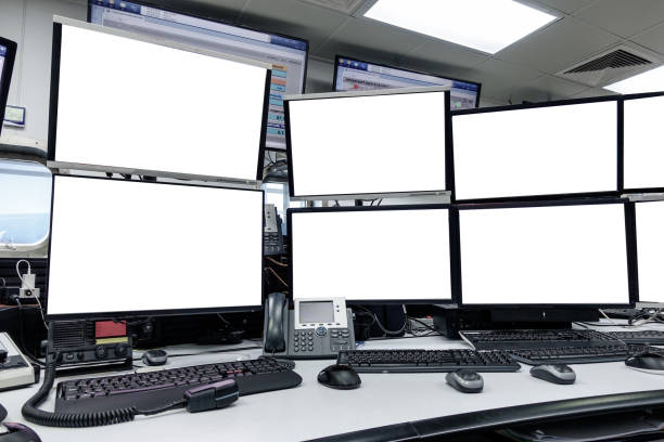 group of blank monitors and screen on security desk or control room for monitor process or stock data trading. stock photo