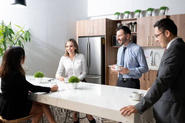 Group of business people having coffee break Group of business people having coffee and chatting in office cafeteria cafeteria stock pictures, royalty-free photos & images