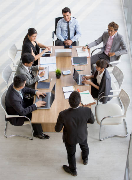 Group of business People Meeting Conference in office . marketing team Brainstorming Teamwork together at workspace.Discussion Corporate coworkers discussing Financial . multi-ethnic. High angle view stock photo