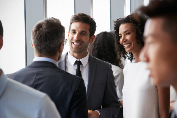 Group Of Businesspeople Having Informal Office Meeting Group Of Businesspeople Having Informal Office Meeting event stock pictures, royalty-free photos & images