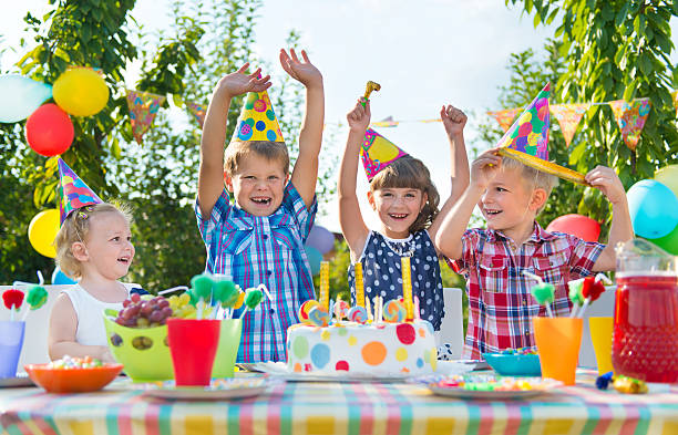 Group of children celebrating at a birthday party stock photo