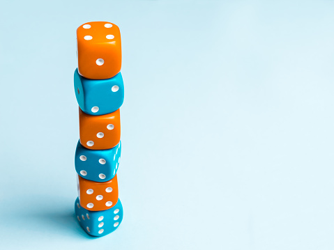 A group of colored dice placed in a column on top of each other