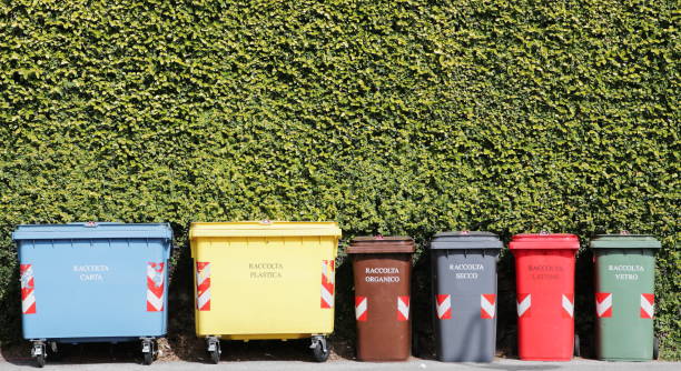 Group of coloured recycling bins on the street for paper plastic organic dry can and glass in Italy stock photo