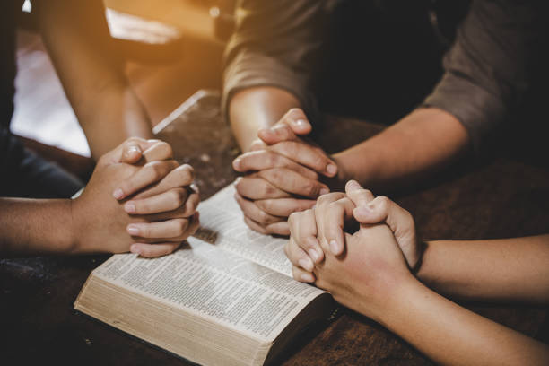 Group of different women praying together stock photo