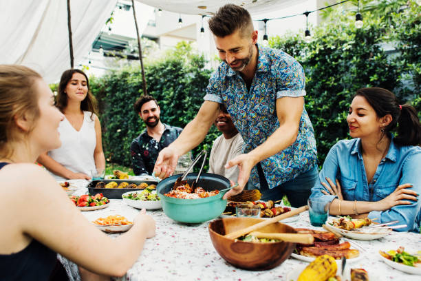 Group of diverse friends enjoying summer party together Group of diverse friends enjoying summer party together barbecue meal stock pictures, royalty-free photos & images