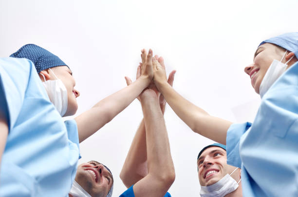 Group of doctors doing high-five stock photo