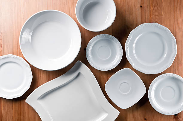 group of elegant china, everyday ceramics tableware on wooden table - bord serviesgoed stockfoto's en -beelden