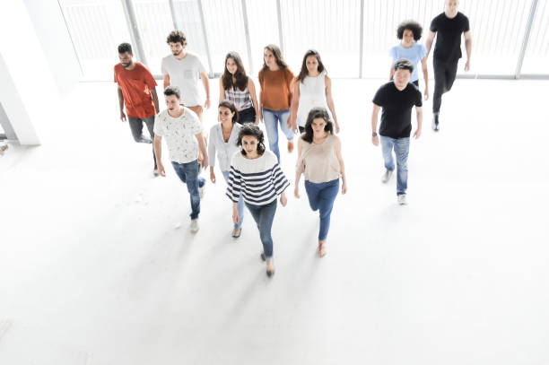 Group of enthusiastic business people walking stock photo