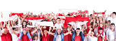 Large group of cheerful fans cheering. They are wearing white and red t-shirts. Isolated on white.   