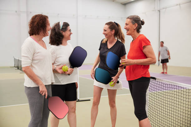 A group of friends chats after the pickleball game. stock photo