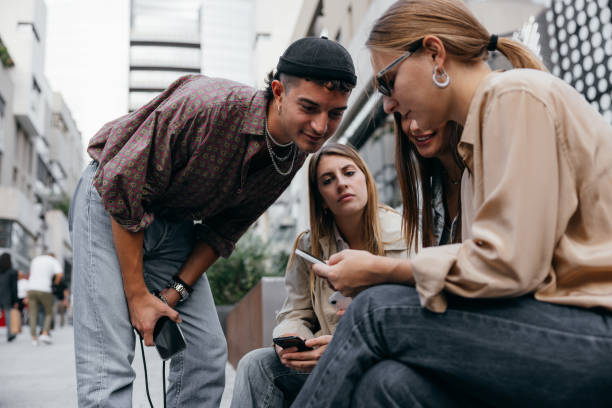 Group of generation Z friends looking on social media stock photo