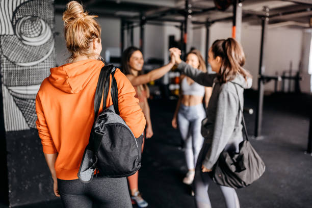 Group of gymters greeting on the way in to workout stock photo