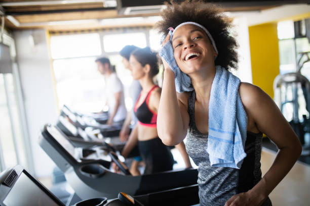 Group of healthy fit people at the gym exercising Group of happy fit people at the gym exercising exercise machine stock pictures, royalty-free photos & images