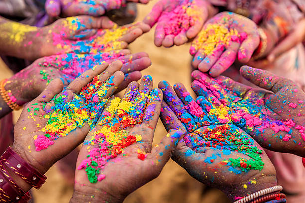 Group of Indian children playing holi in Rajasthan, India Group of Indian children playing happy holi in Rajasthan, India. Indian children keeping their hands up and showing colorful powders. Holi, the festival of colors, is a religious festival in India, celebrated, with the color powders, during the spring. holi photos stock pictures, royalty-free photos & images