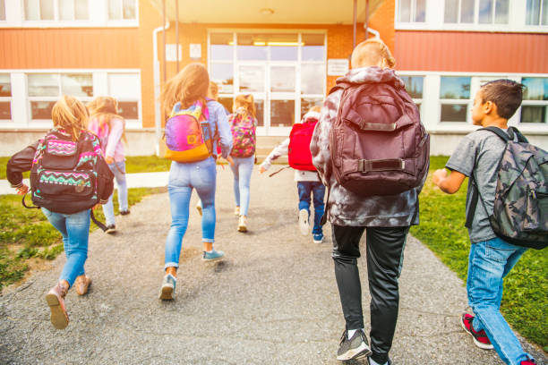 group of kids go to the school, Back view A group of kids go to the school. Back view recess stock pictures, royalty-free photos & images