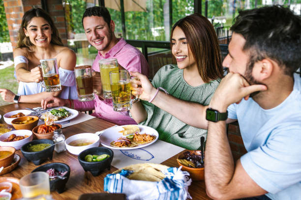 Group of latin friends eating mexican food in the restaurant terrace in Mexico Latin America stock photo