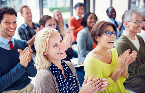 Group of Multiethnic Cheerful People Applauding Group of Multiethnic Cheerful People Applauding entertainment event stock pictures, royalty-free photos & images