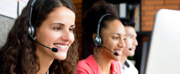 Group of multiethnic smiling call center team Group of multiethnic smiling call center team - panoramic web banner cross section stock pictures, royalty-free photos & images