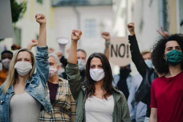 Group of people activists protesting on streets, women march and demonstration concept. Portrait of group of people activists protesting on streets, women march and demonstration concept. anti vaccination stock pictures, royalty-free photos & images