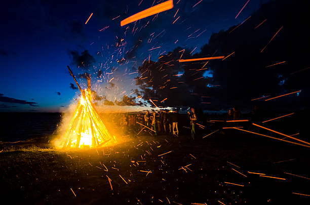 Group of people celebrating June solstice at the bonfire People celebrating summer solstice bonfire stock pictures, royalty-free photos & images