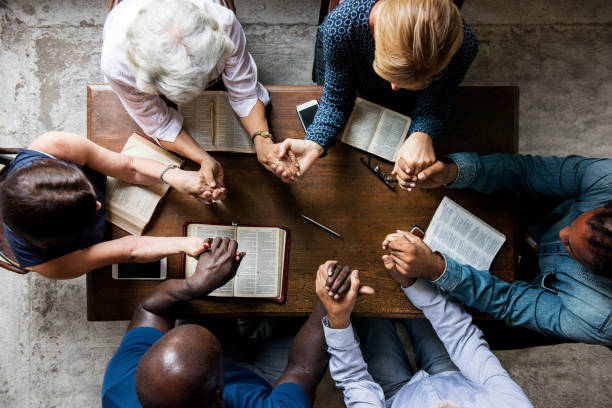 Group of people holding hands praying worship believe  christians  stock pictures, royalty-free photos & images