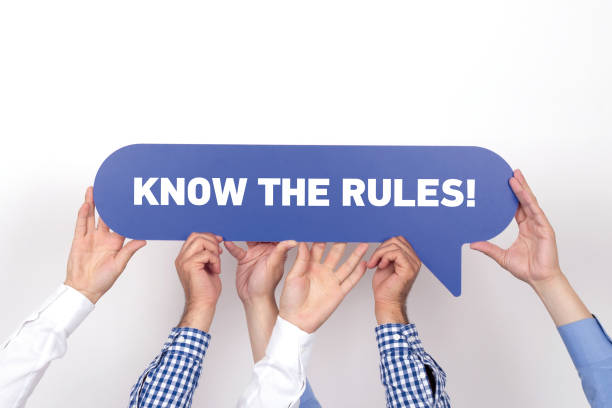 Group of people holding the KNOW THE RULES! written speech bubble stock photo
