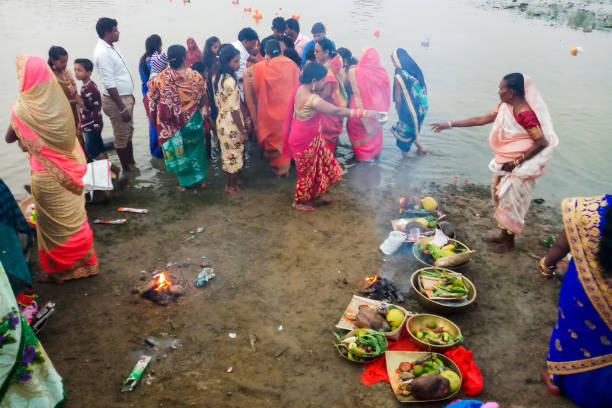 A group of people is celebrating the Chhath Puja Patna, Bihar, India - November 02, 2019; A festival is held in November in Bihar, Jharkhand, and Uttar Pradesh, in India where devotees celebrate this puja on the banks of rivers or ponds. In the local language, it is called Chhath Puja. chhath stock pictures, royalty-free photos & images